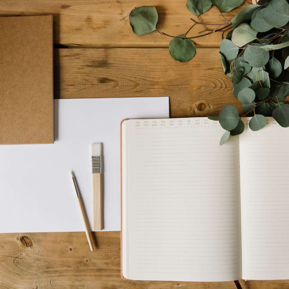 Notebooks on Top of a Wooden Table
